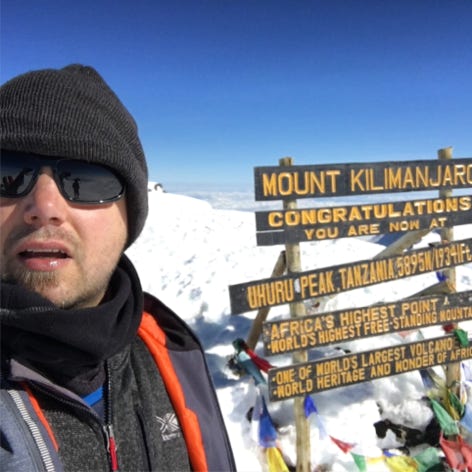 Picture of Luke Hamlyn at the summit of Mount Kilimanjaro